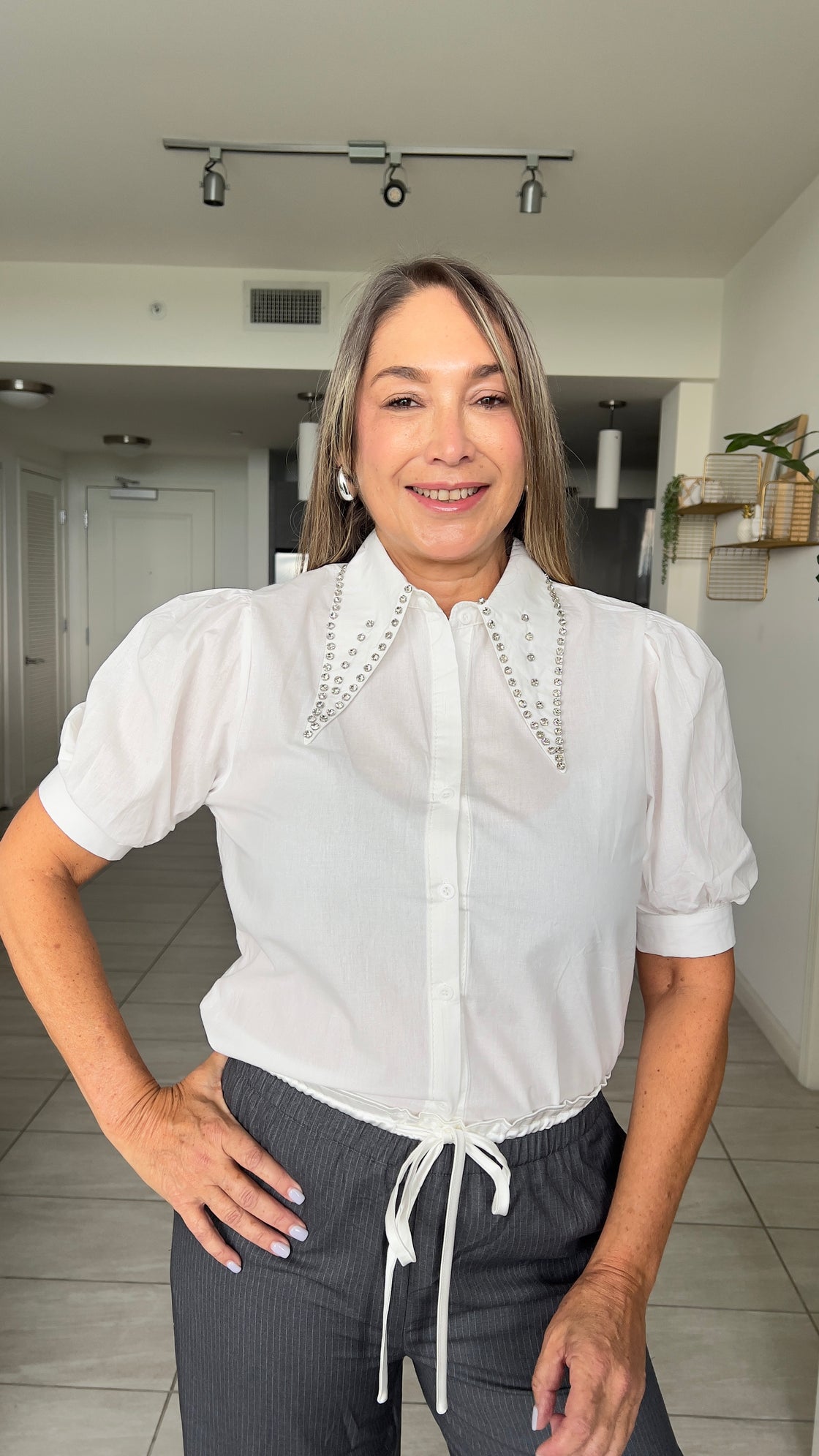 white shirt with strack details on its collar