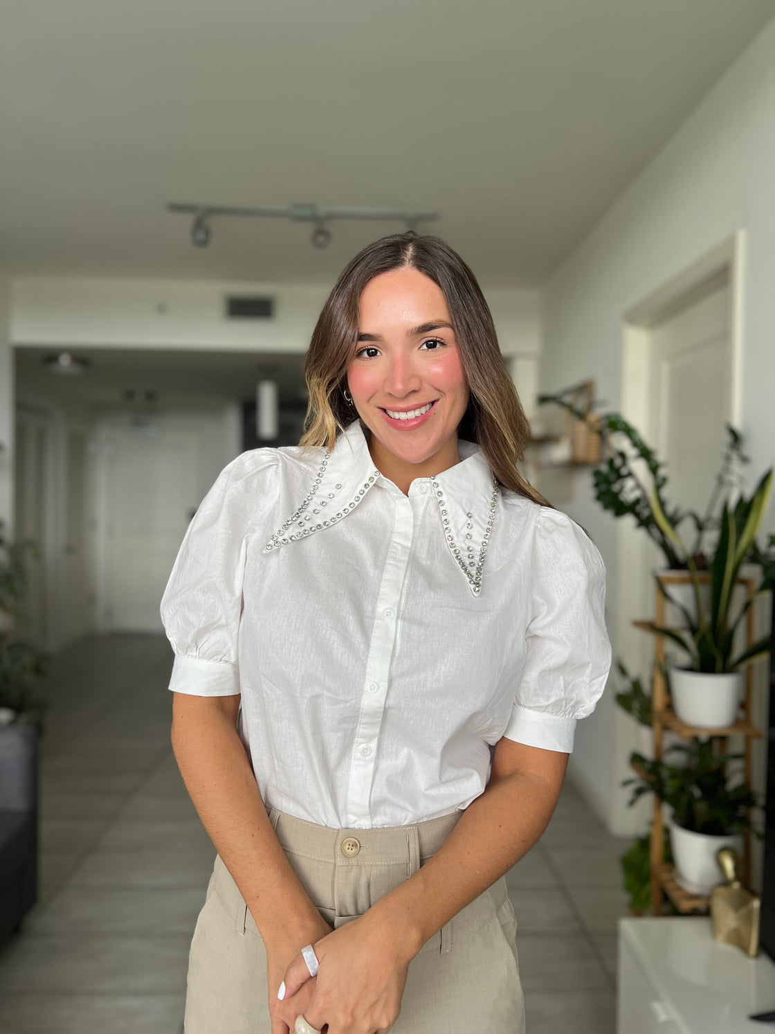 white shirt with strack details on its collar