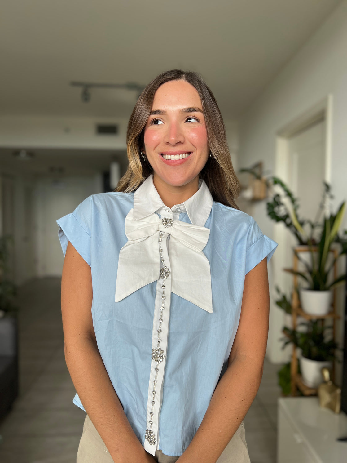 baby blue shirt with white bow on the front