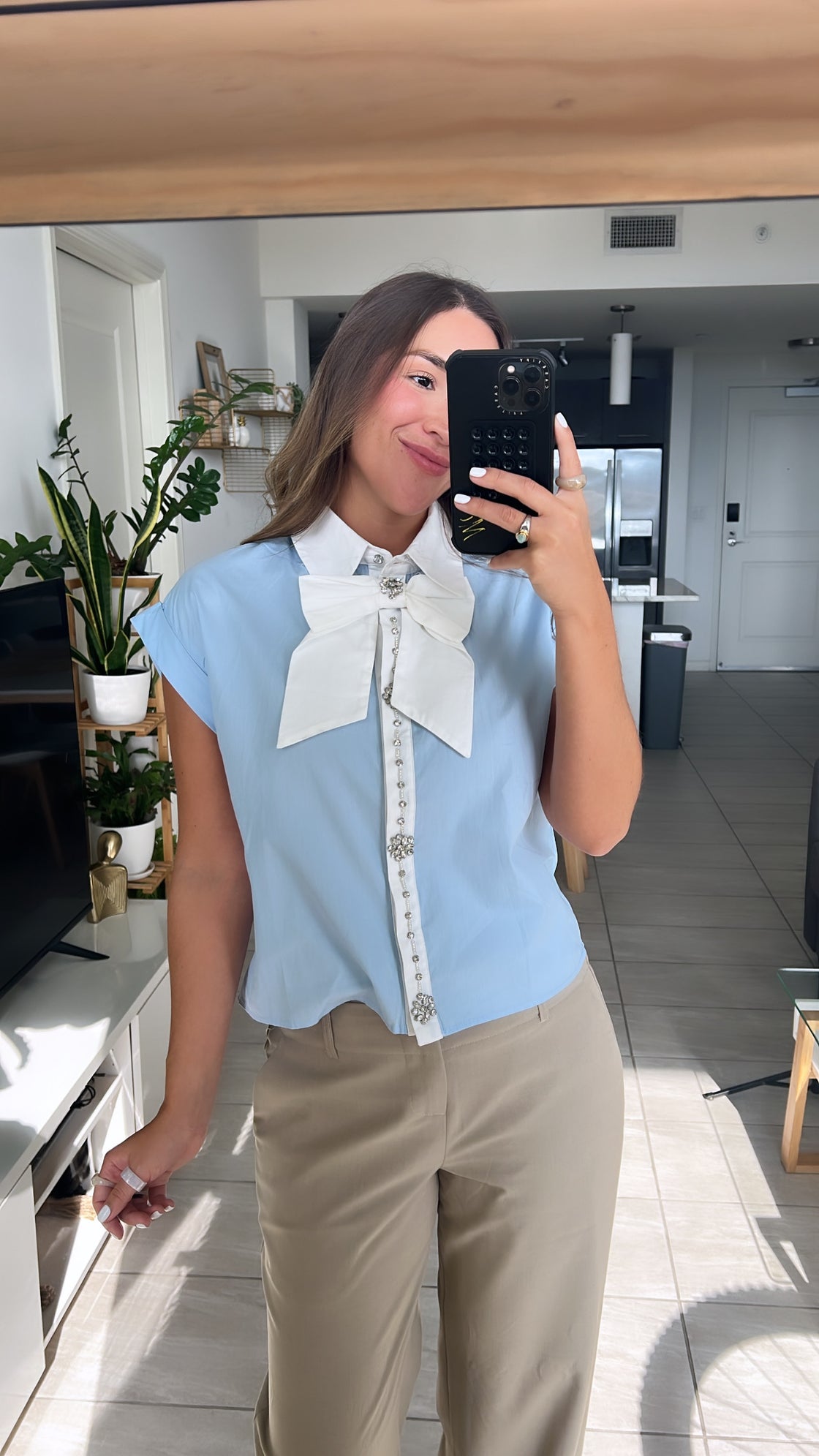baby blue shirt with white bow on the front
