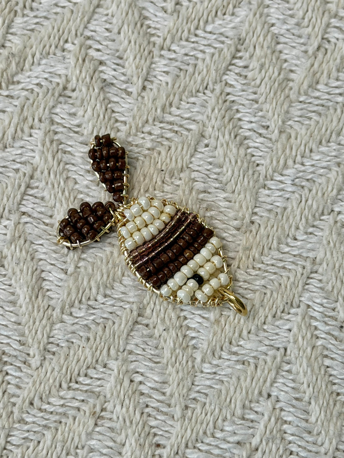 Natural stone necklace with a handmade fish-shaped pendant.