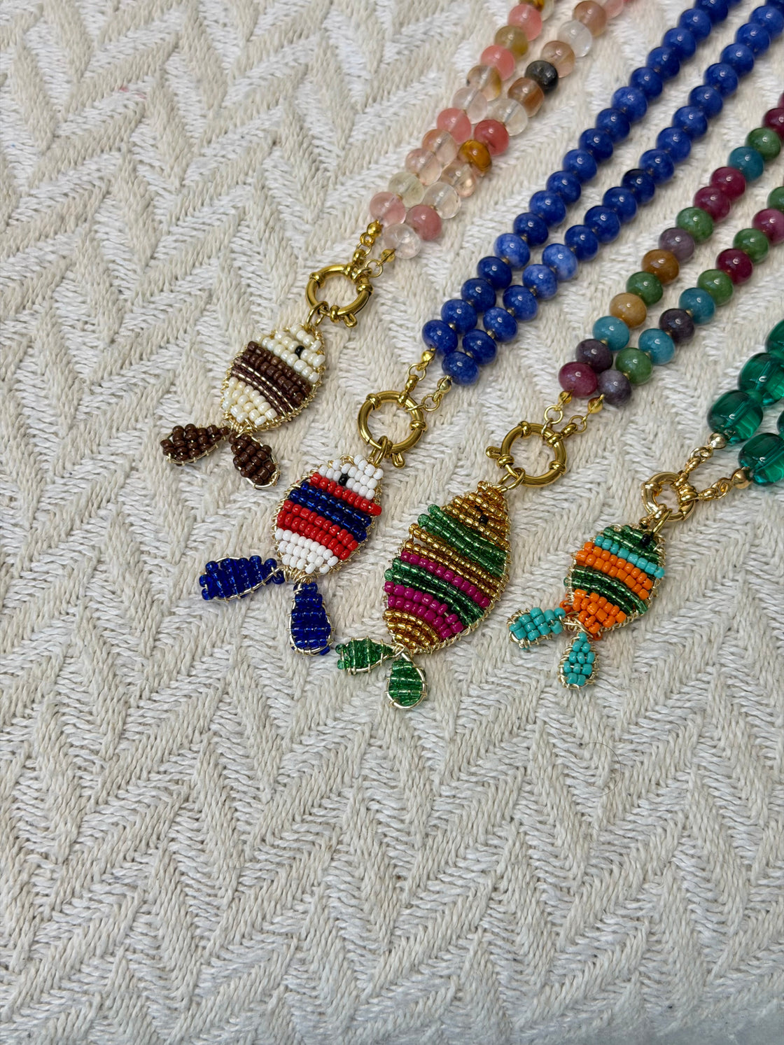 Natural stone necklace with a handmade fish-shaped pendant.