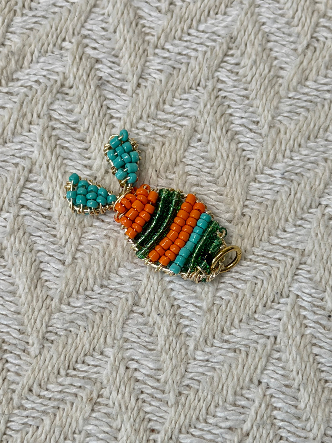 Natural stone necklace with a handmade fish-shaped pendant.